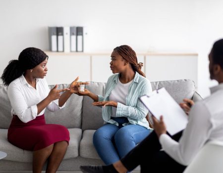 african-american-lesbian-couple-having-consultation-with-psychologist-at-office.jpg